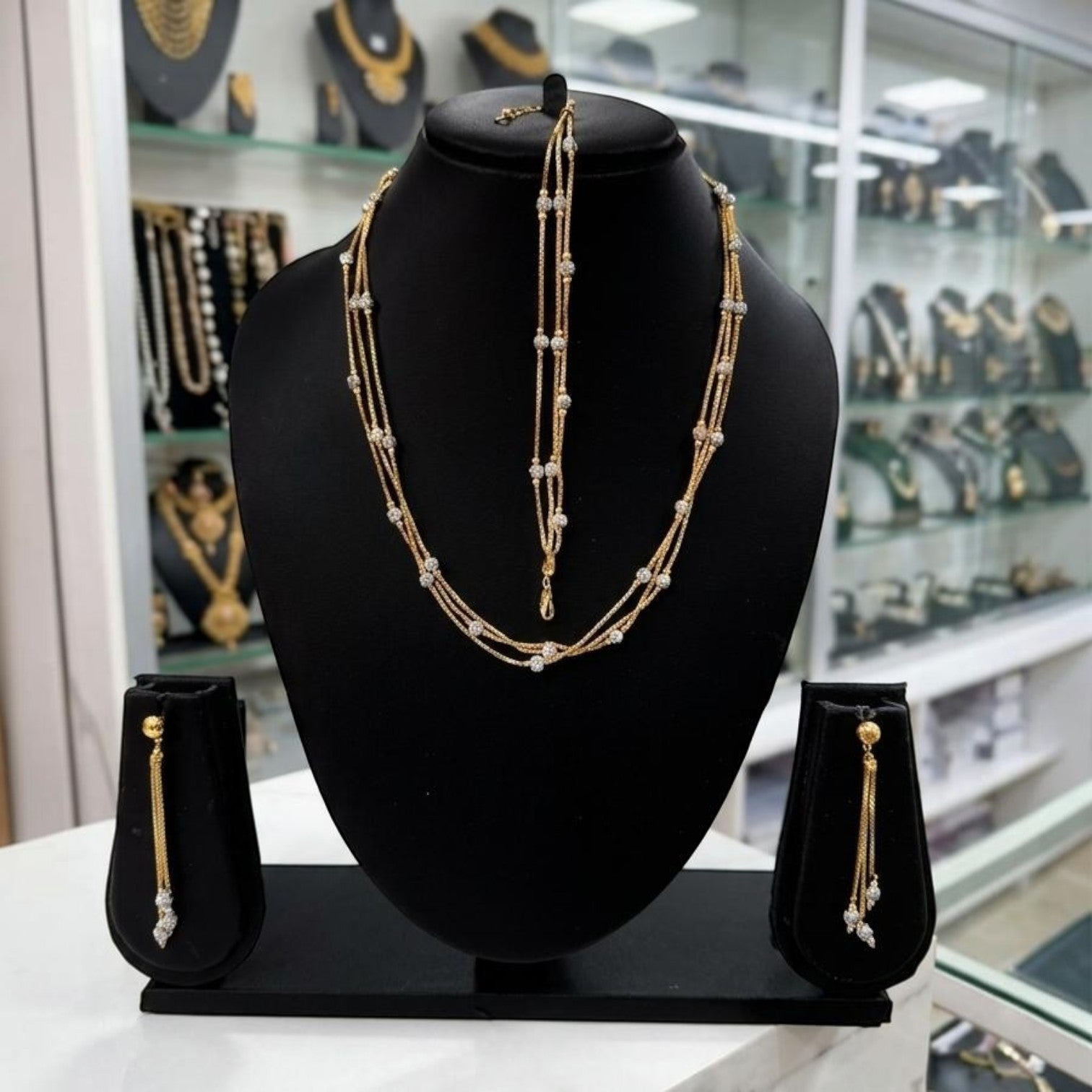 JewelOnChain bracelet and earring combo set in gold with crystal accents. Delicate layered chains.