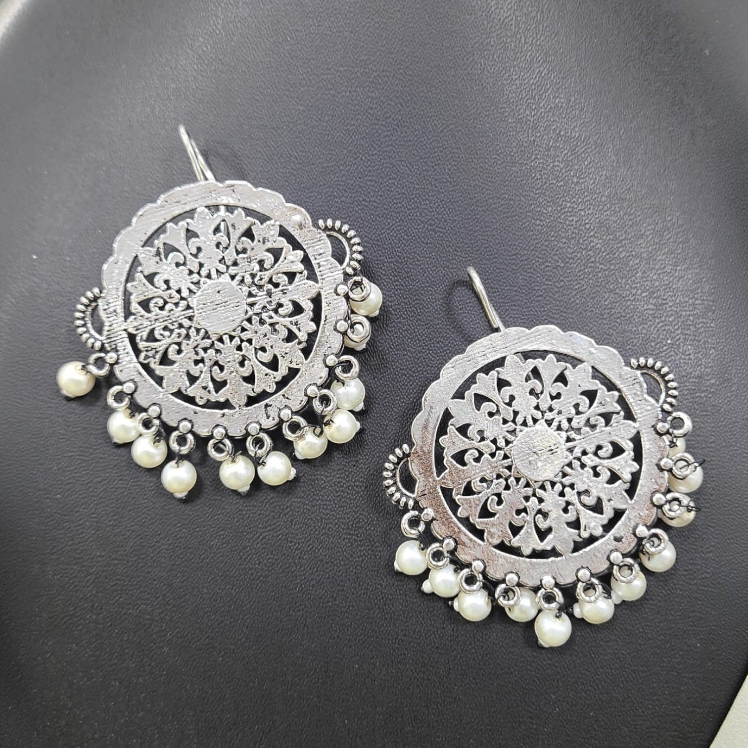 JewelOn Elegant German Silver Oxidised Round Earrings with pearl drops and intricate floral design.