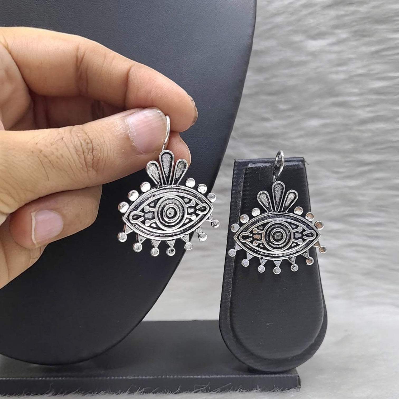 JewelOn Limited German Silver Evil Eye Dangle Earrings with intricate detailing and beaded accents.