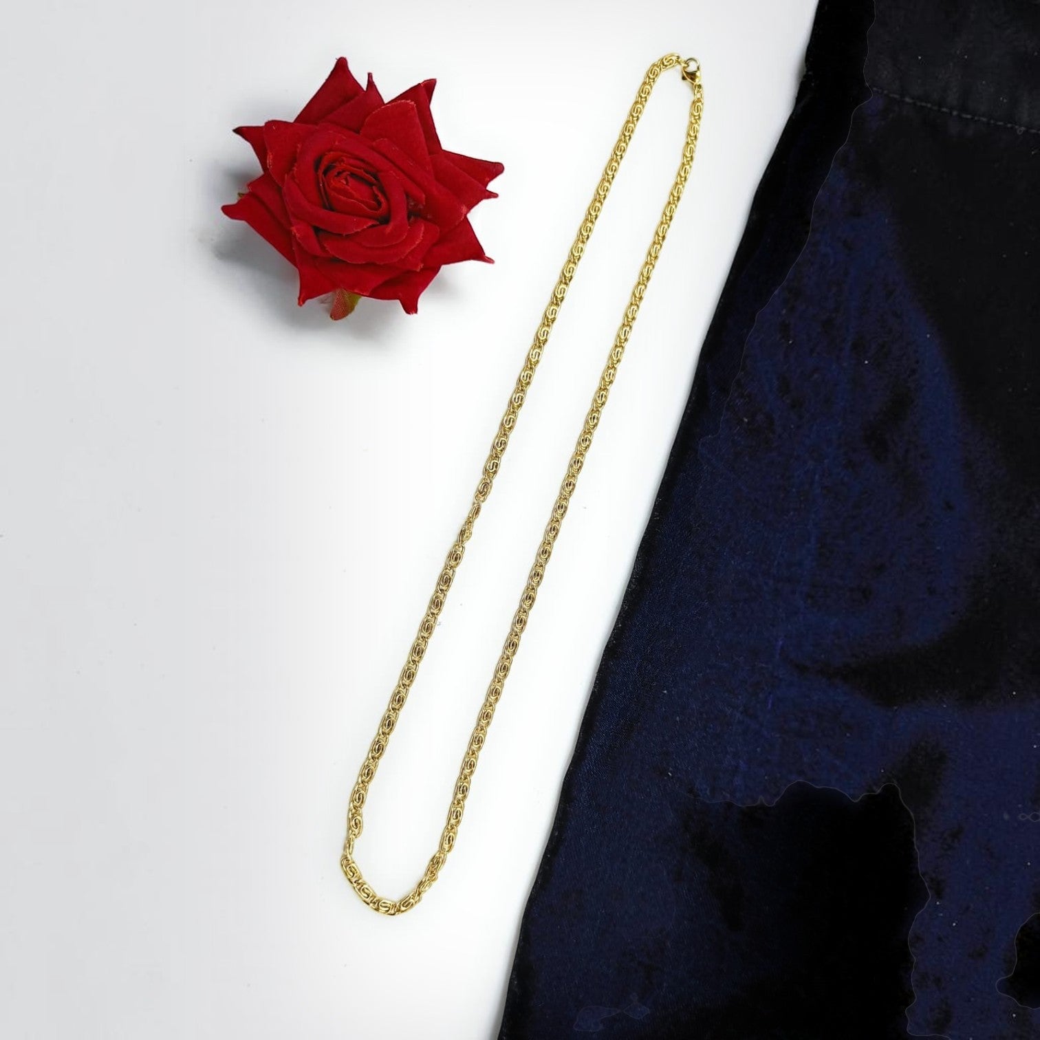 JewelOn 24-inch gold chain necklace with a textured link design, displayed with a red rose and dark fabric.