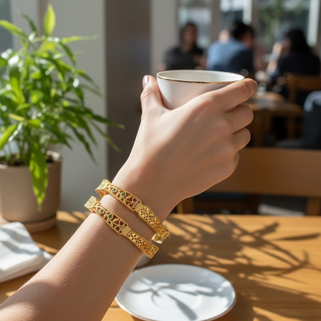 JewelOn gold plated artificial bangles set with intricate floral cutwork and colorful stone accents.
