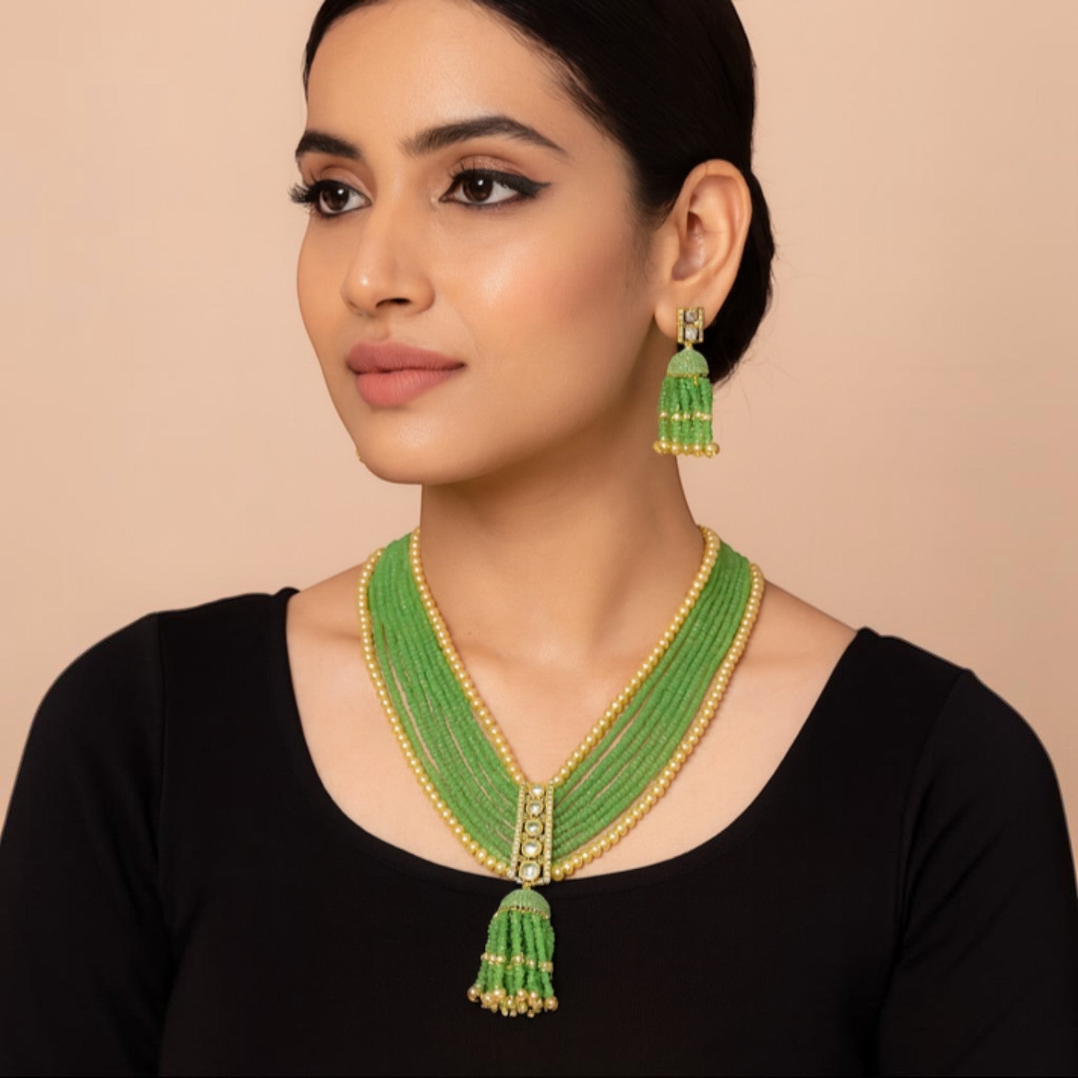 JewelOn green beaded necklace and tassel earrings set with gold accents and pearl details.