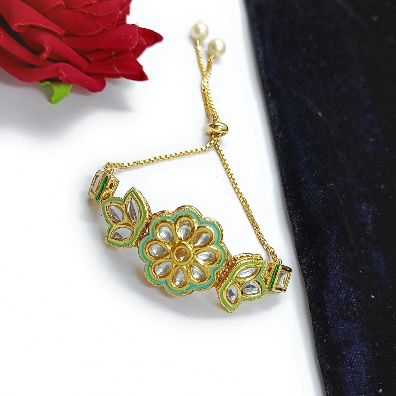 JewelOn gold-tone adjustable bracelet with floral kundan stones and mint green enamel detail. Features pearl accents.