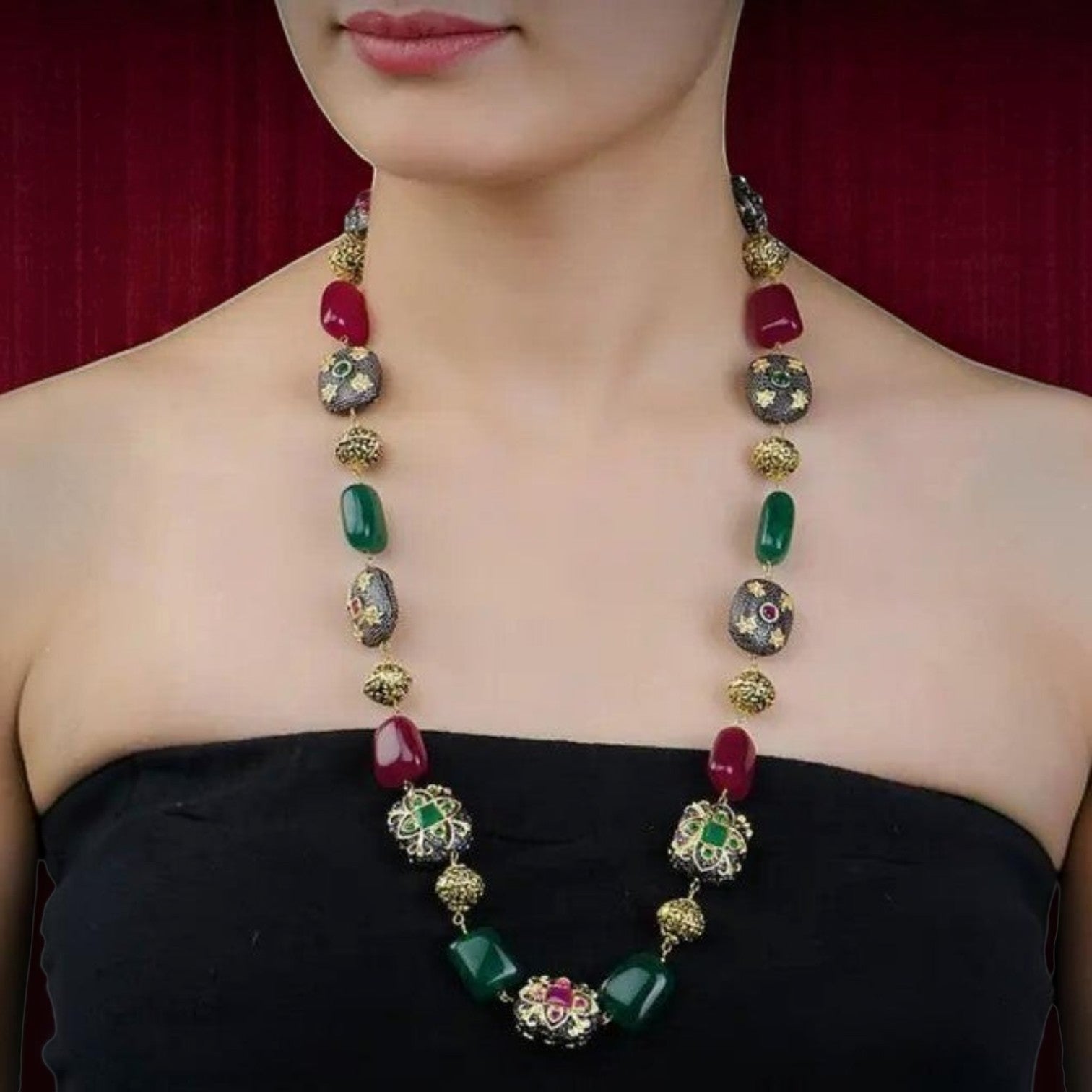 Jewelon fusion semiprecious stone mala necklace set with red and green stones and gold accents.