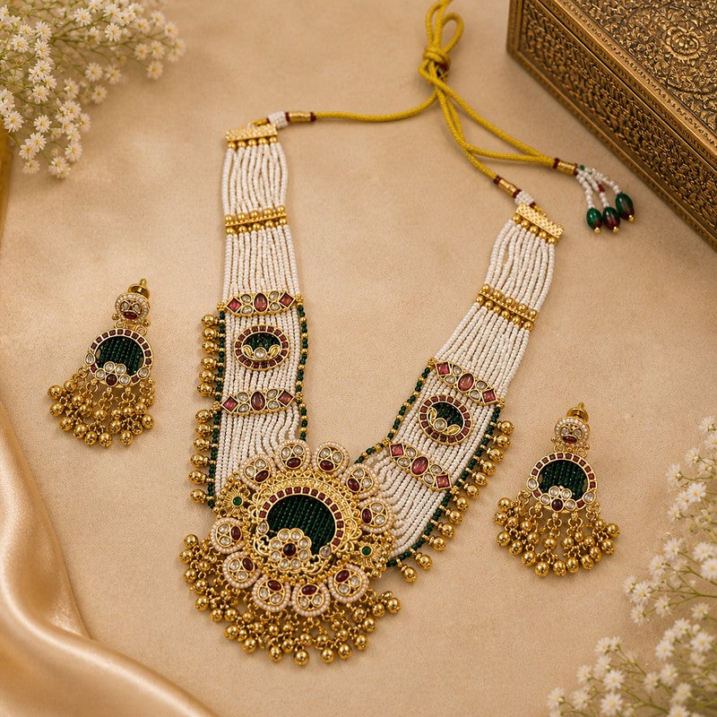 JewelOn heritage necklace set with maroon and green pearls, gold-toned metal, and intricate floral design. Includes matching earrings.