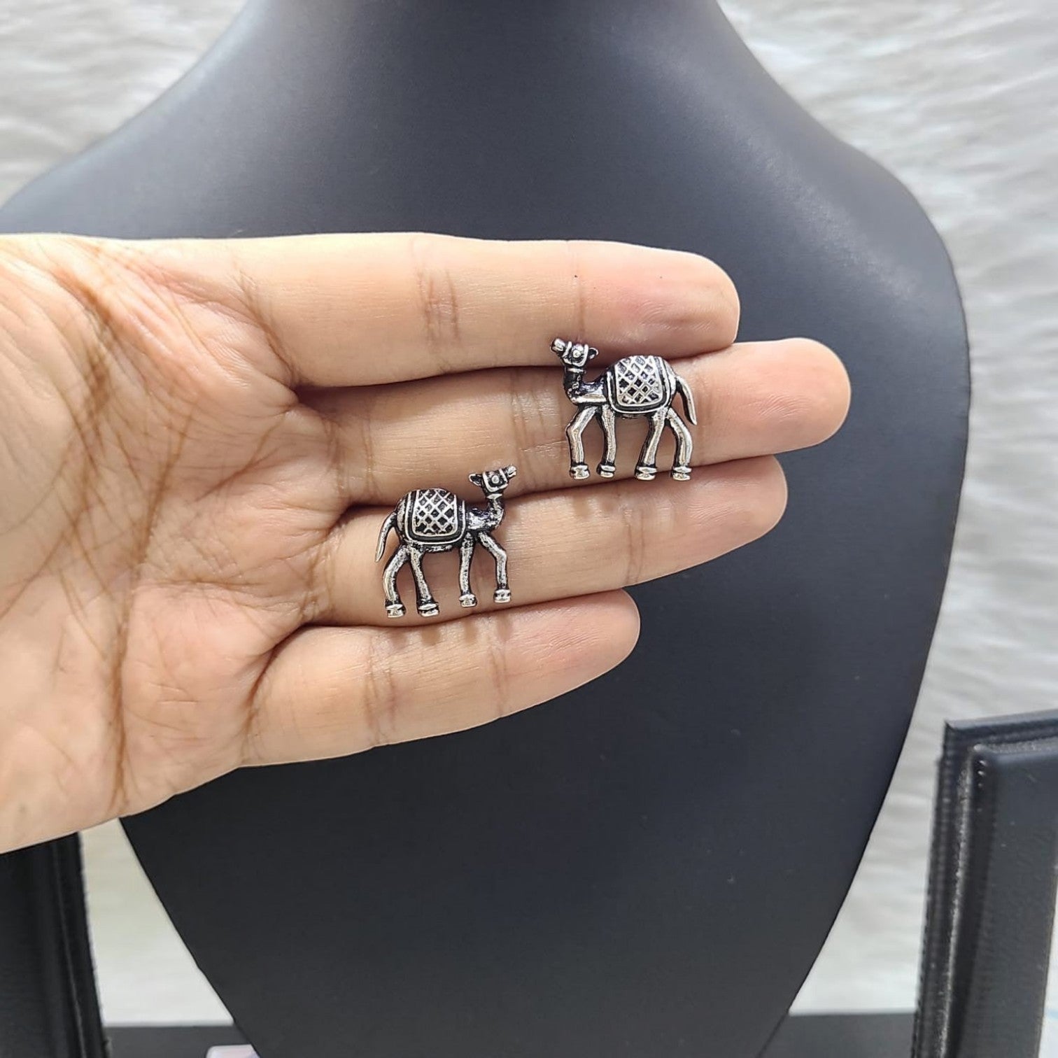 JewelOn Dreamy German Silver Oxidised Camel Earrings with intricate saddle detail.