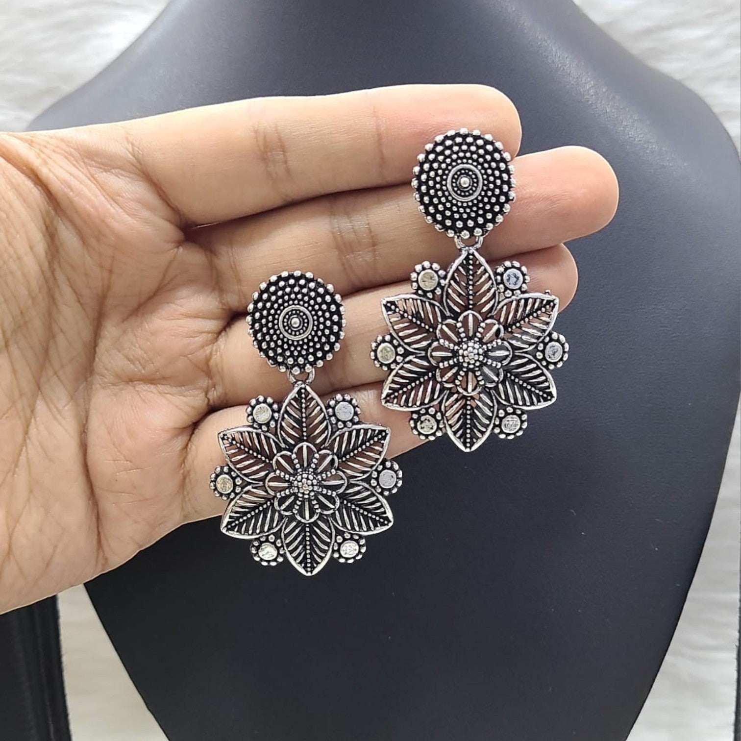 JewelOn stylish oxidised German silver floral drop earrings with intricate leaf details.