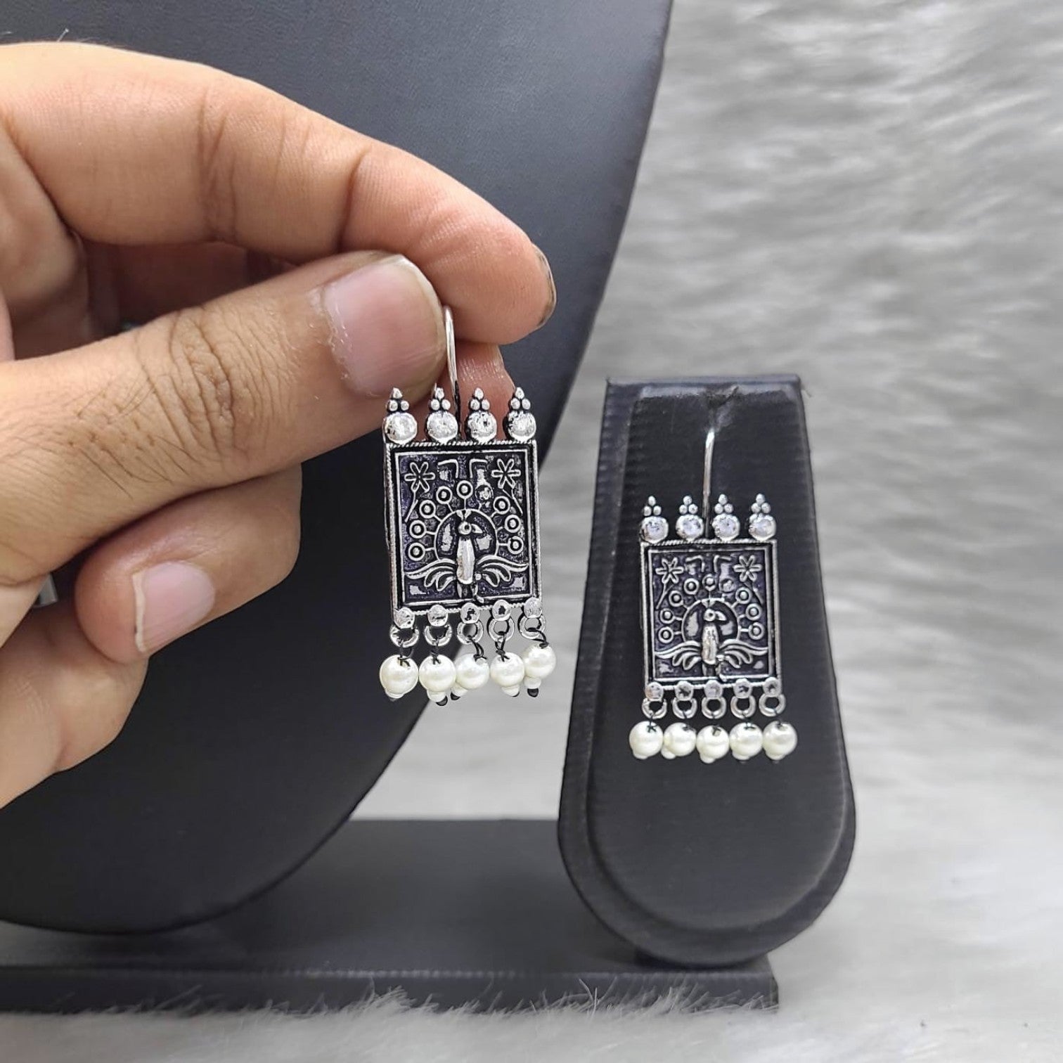 JewelOn Iconic German Silver Oxidised Earrings with pearl drops and intricate peacock design.
