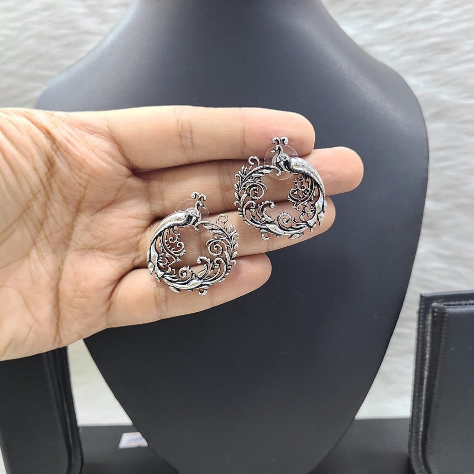 JewelOn Dazzling German Silver Oxidised Peacock Earrings with intricate scrollwork design.