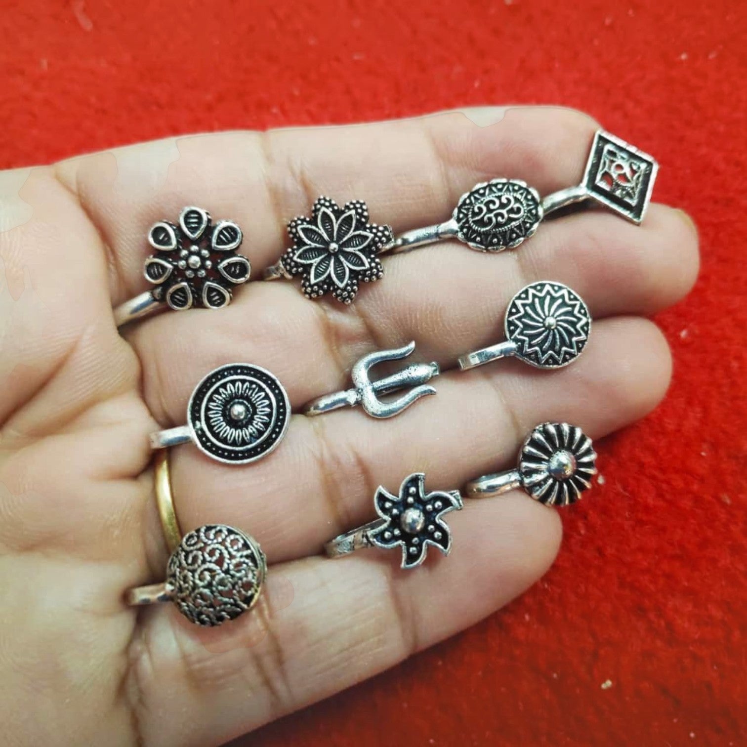 JewelOn pack of 10 assorted oxidised silver nose pins with floral and geometric designs.