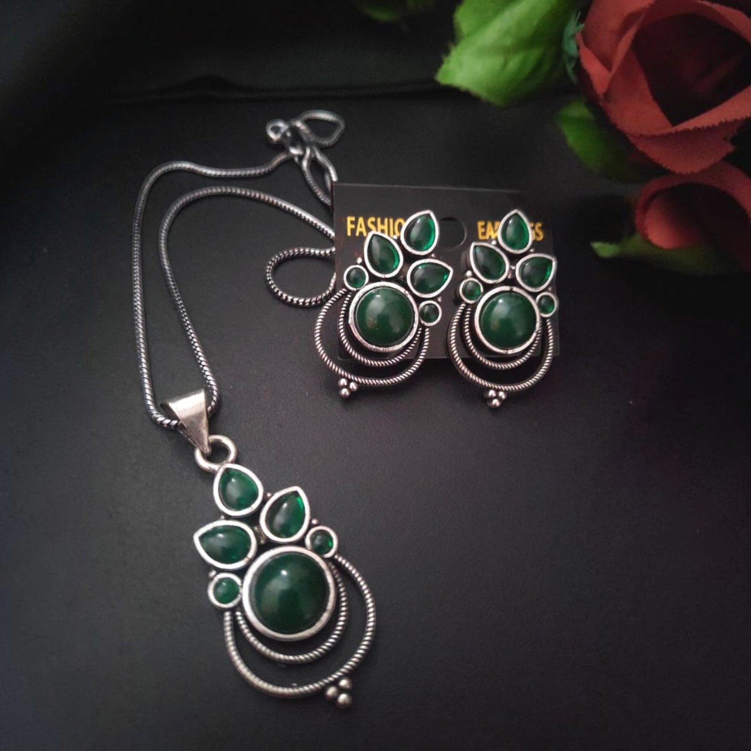 JewelOn polished gleam classy oxidised pendant necklace and earrings set with green stones.