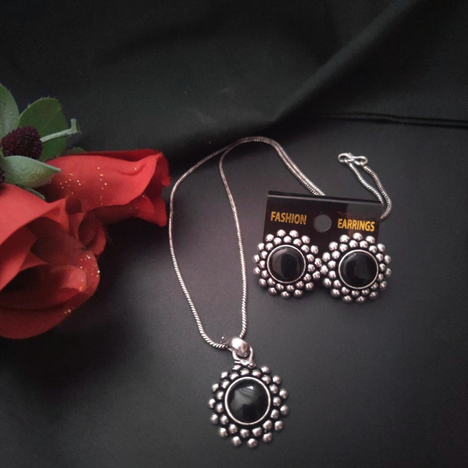 JewelOn Amara oxidised silver pendant necklace and matching earrings with black stone centres and floral details.