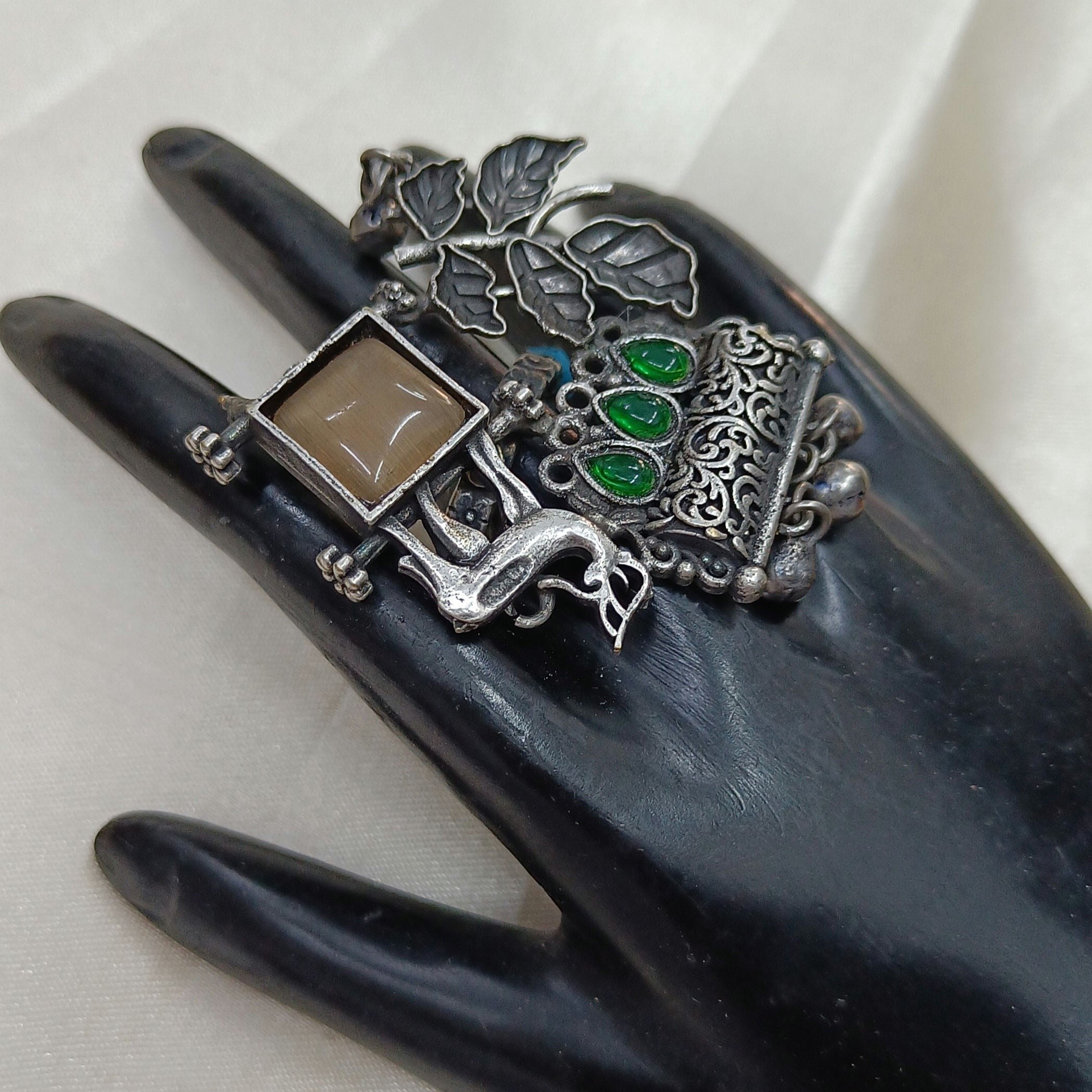 JewelOn oxidised silver plated ring with a square beige stone, green accent stones, and intricate leaf and animal motifs.