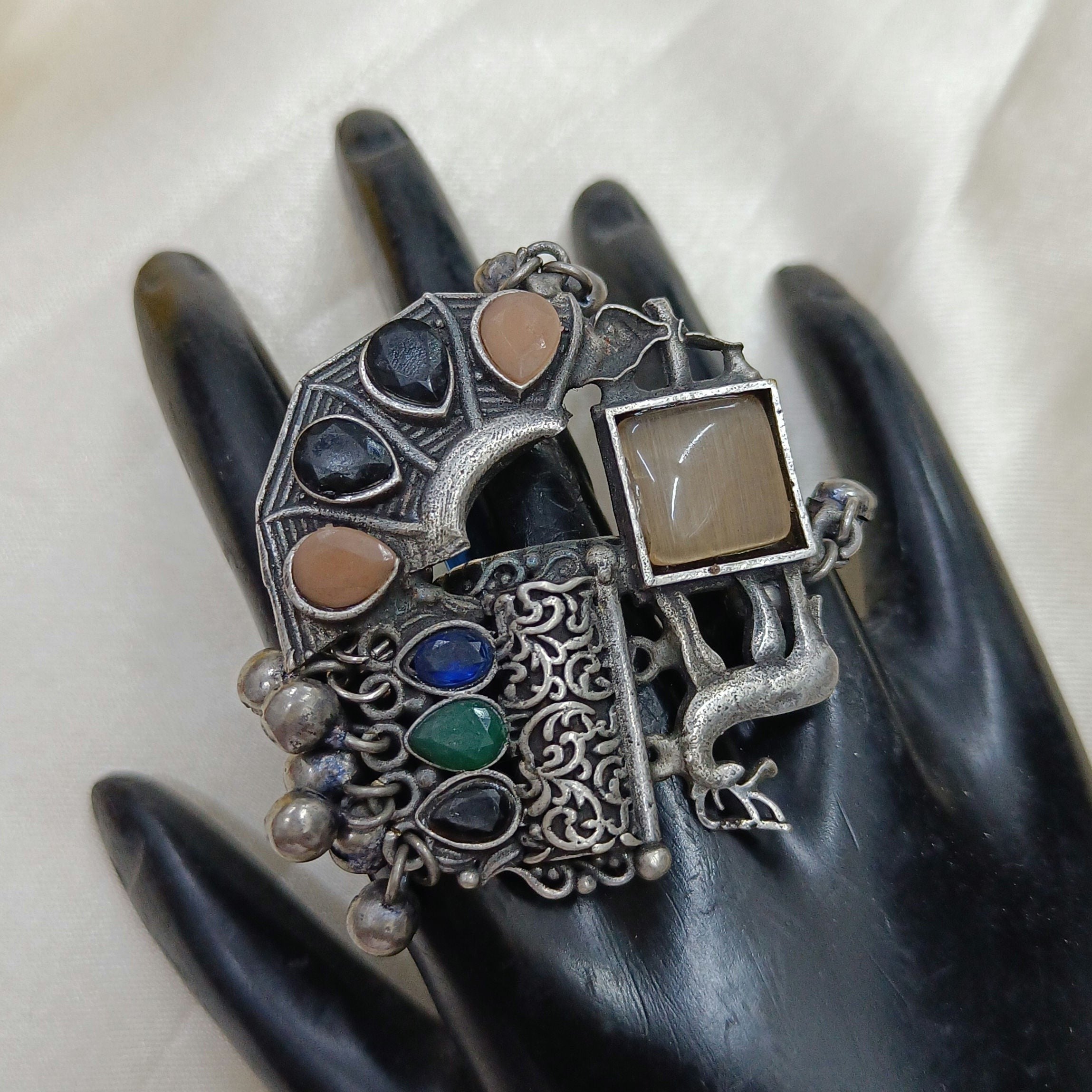 JewelOn oxidised silver plated ring with multiple colourful stones and a square beige stone. Features intricate detailing and dangling silver beads.