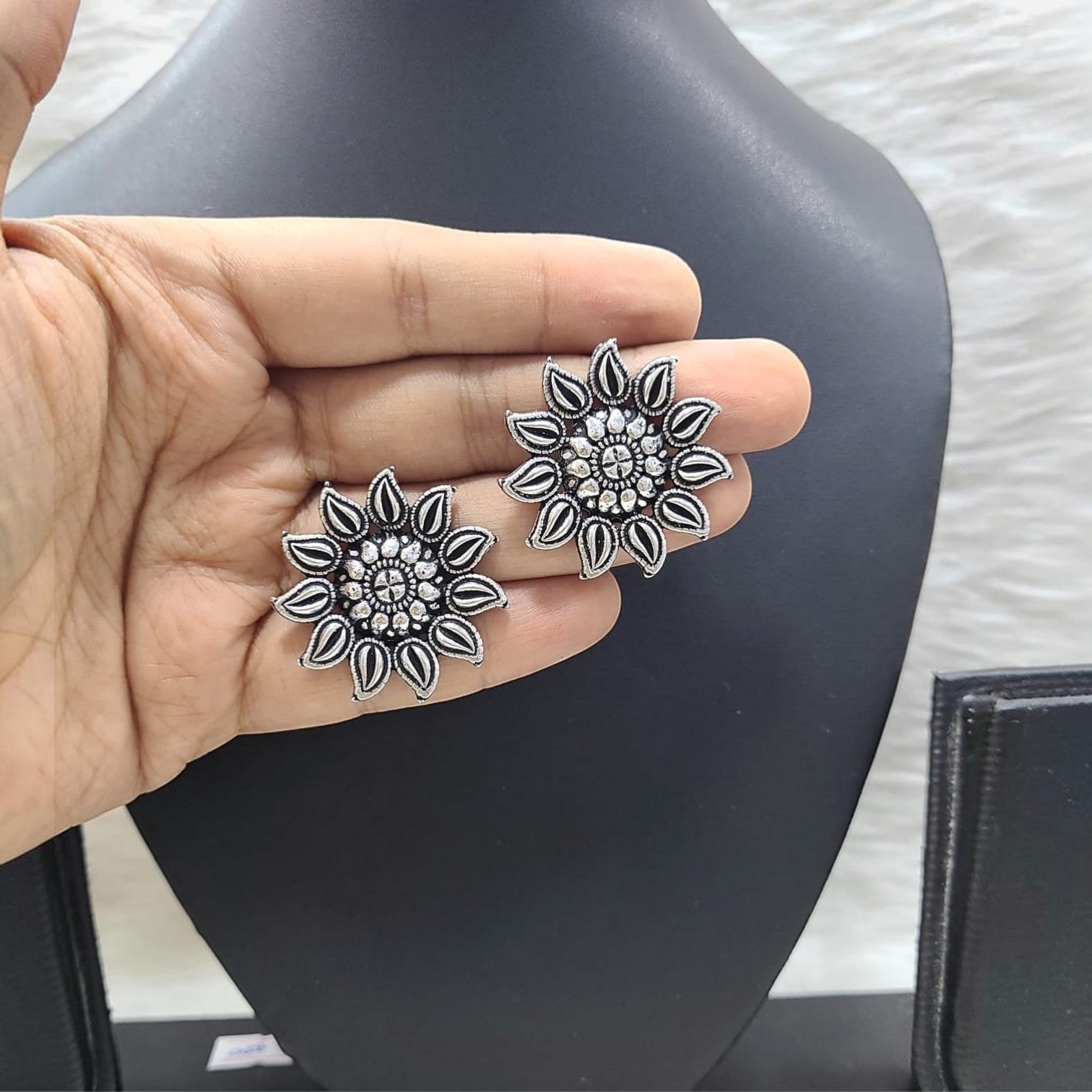 JewelOn authentic German silver oxidized floral stud earrings with intricate detailing.