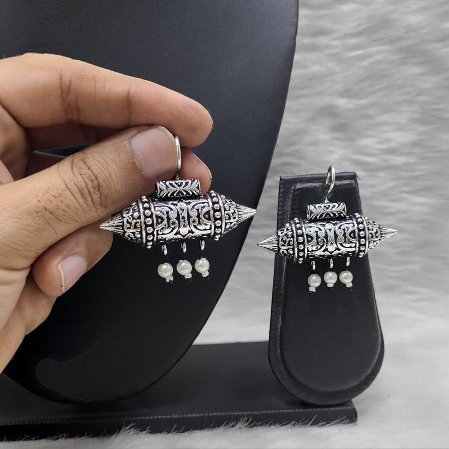 JewelOn delicate German silver oxidized earrings with pearl drops, featuring intricate tribal patterns.