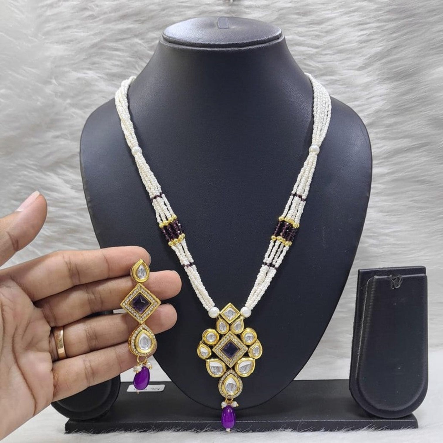 JewelOn purple kundan pendant long necklace set with matching earrings. Intricate gold-tone metalwork with white beads and purple accents.