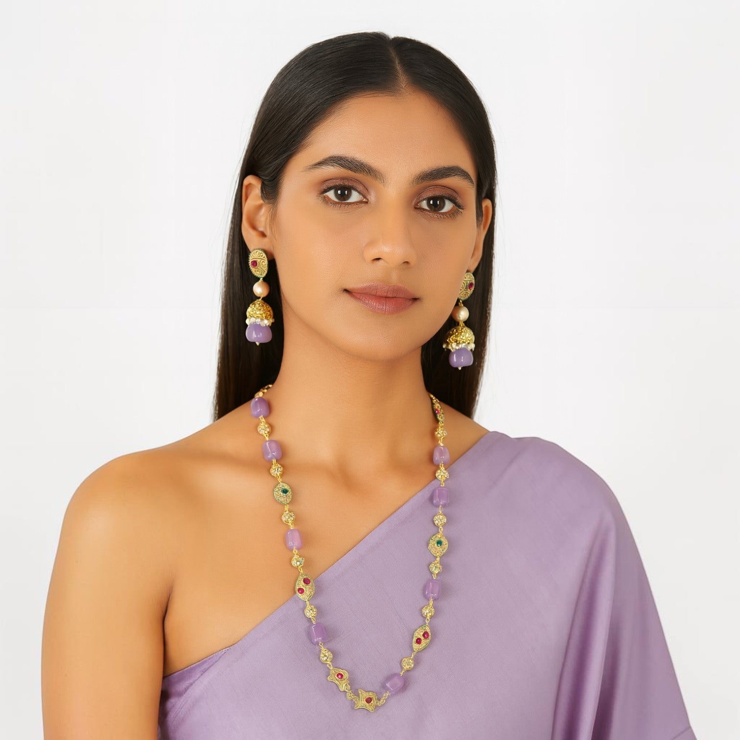 JewelOn necklace and jhumka earrings set with purple stones, pearls, and gold accents. Model wears a lavender outfit.