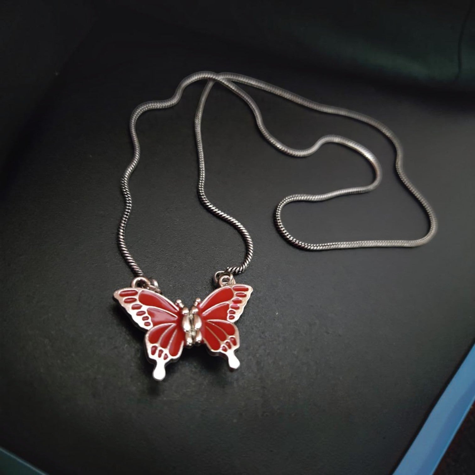 JewelOn red enamel butterfly pendant necklace with silver snake chain. Magnetic closure.