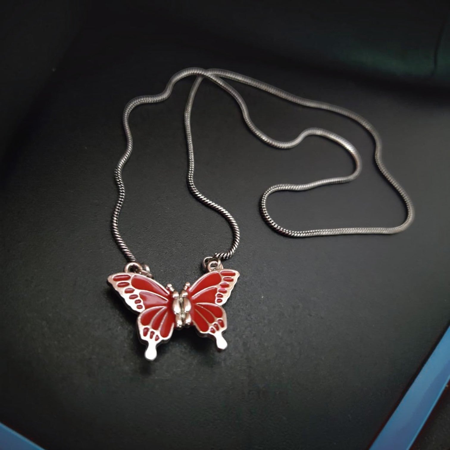 JewelOn red butterfly pendant necklace with silver snake chain, oxidised finish, fusion collection.