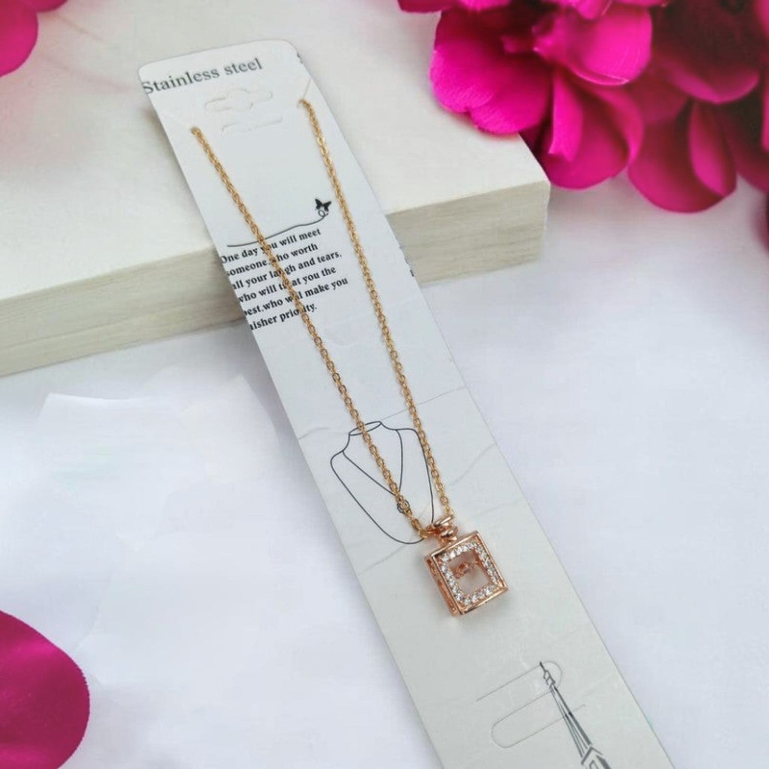 JewelOn Rhea Western pendant necklace with a rose gold chain and a square pendant encrusted with clear stones.
