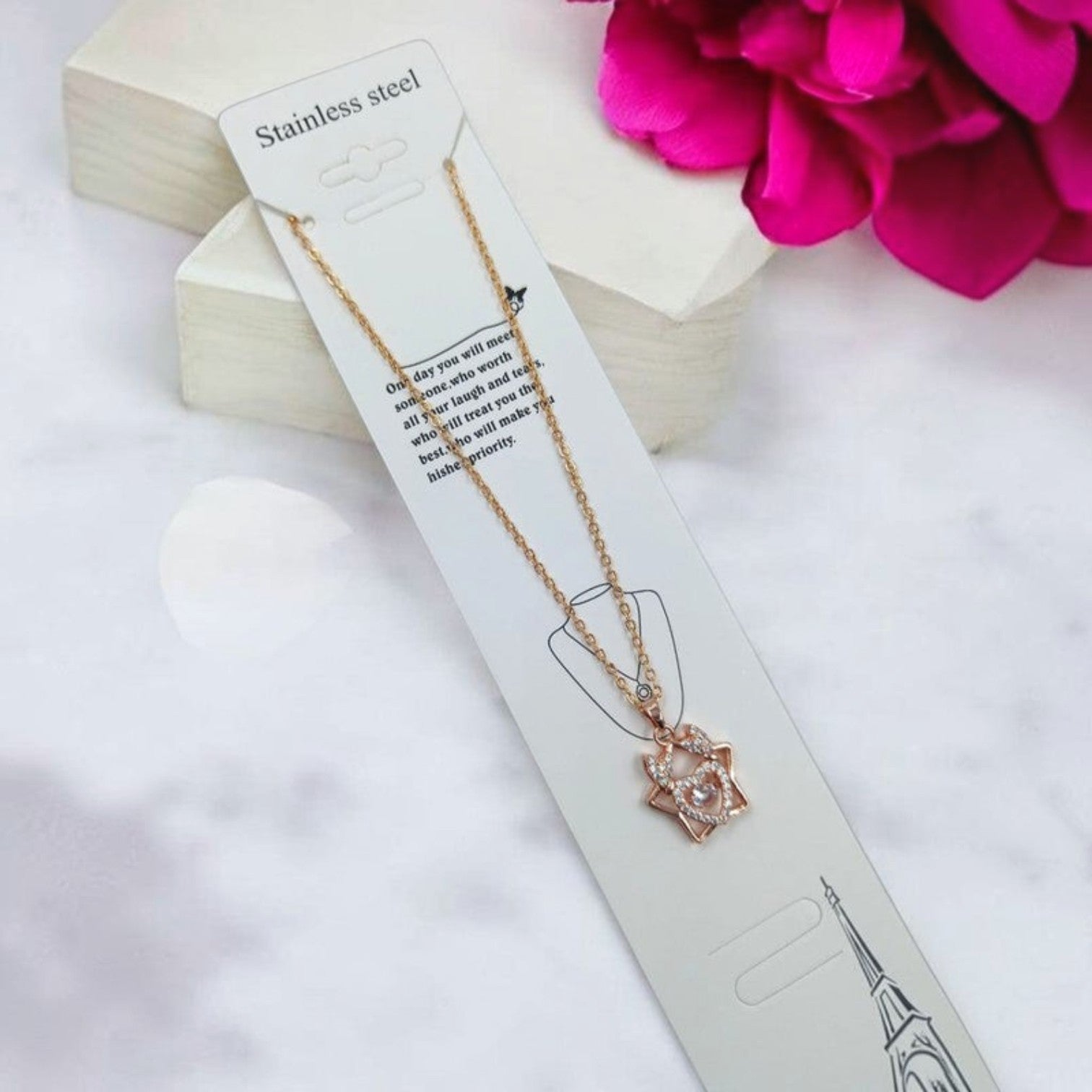 JewelOn Roshni Western pendant necklace with a star-shaped design and a heart-shaped center, adorned with clear stones. Rose gold finish.