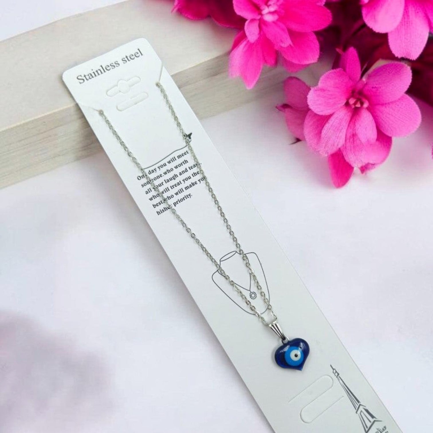 JewelOn silver chain necklace with a blue heart-shaped evil eye pendant, featuring a silver polish finish.