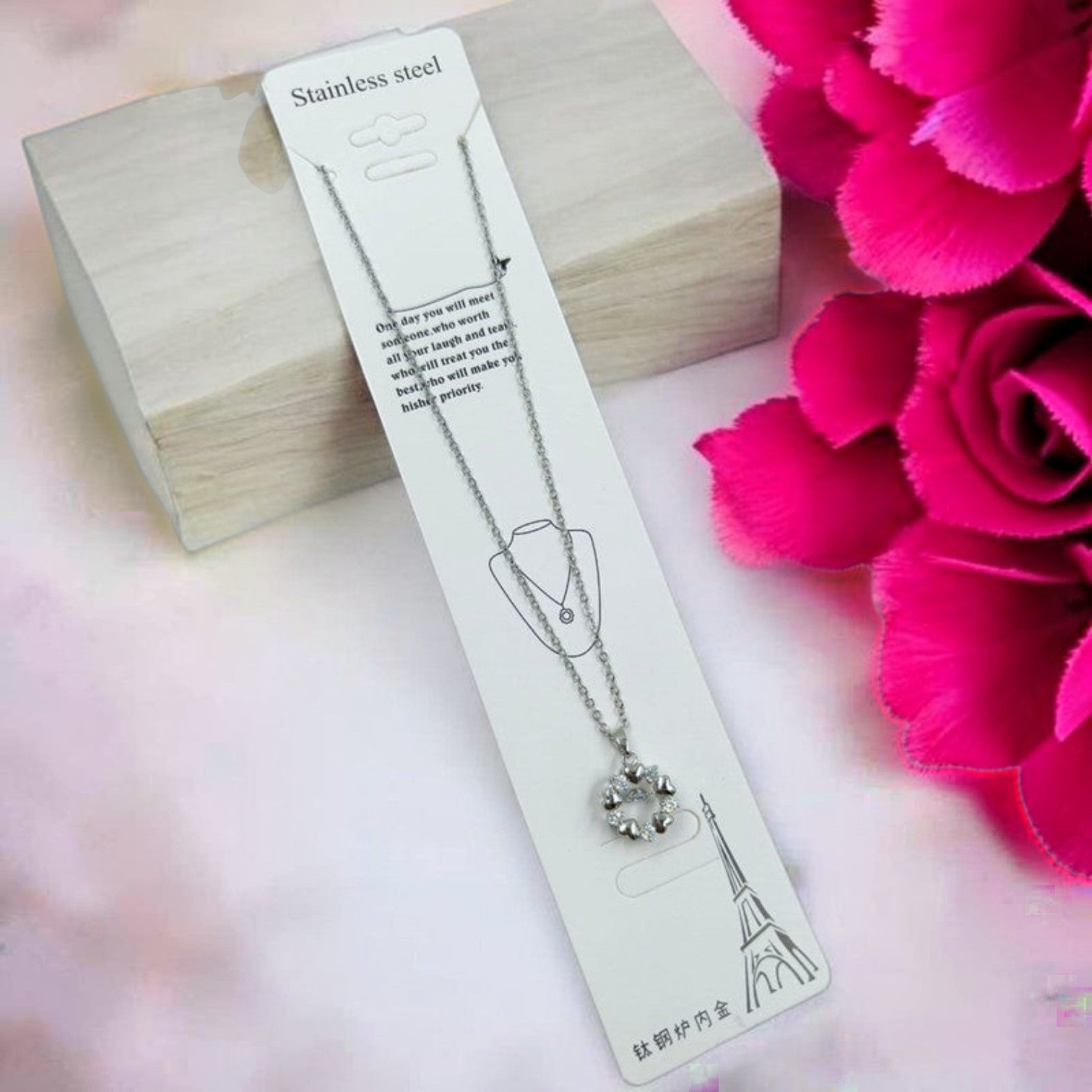 JewelOn silver chain necklace with a circular pendant adorned with clear stones. Stainless steel.