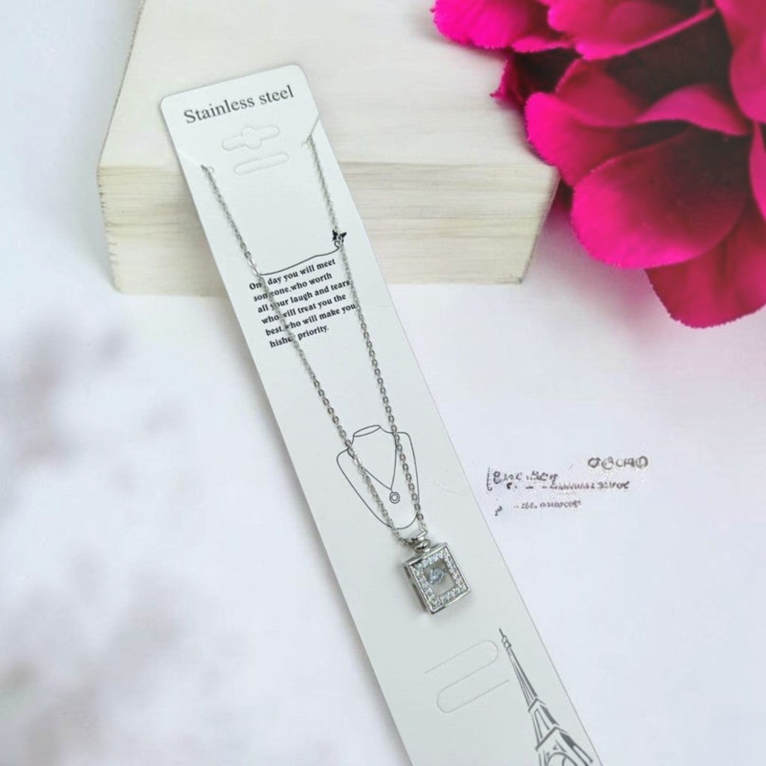 JewelOn silver chain necklace with a square pendant encrusted with clear stones. Stainless steel.