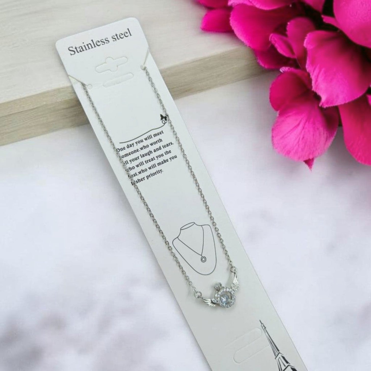 JewelOn silver-tone pendant necklace with a crown and wings design, featuring a clear crystal accent. Stainless steel.