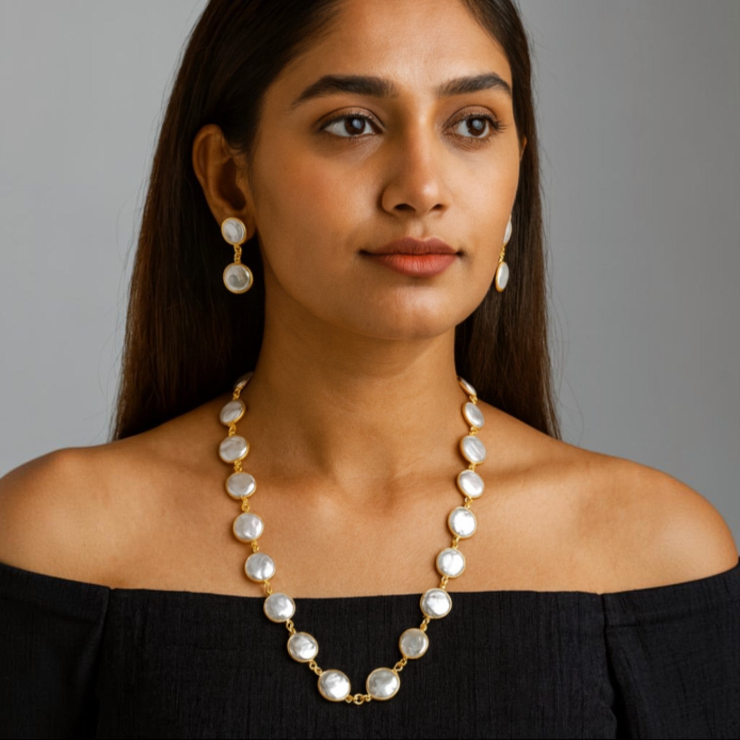 JewelOn white round bead necklace and drop earrings set with gold accents on a model.