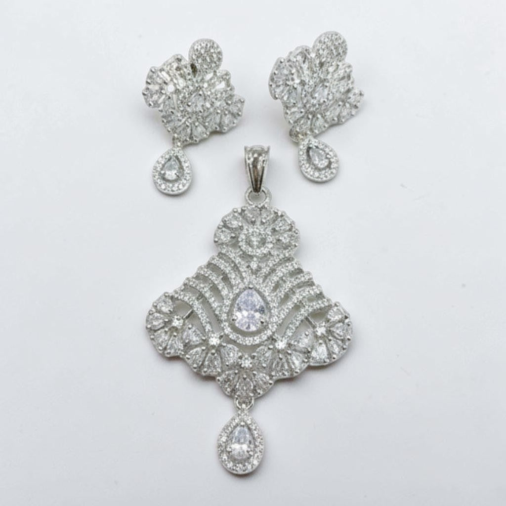 JewelOn Shubhara American Diamond Silver Pendant Earring Set. Intricate silver-toned CZ pendant with matching earrings.