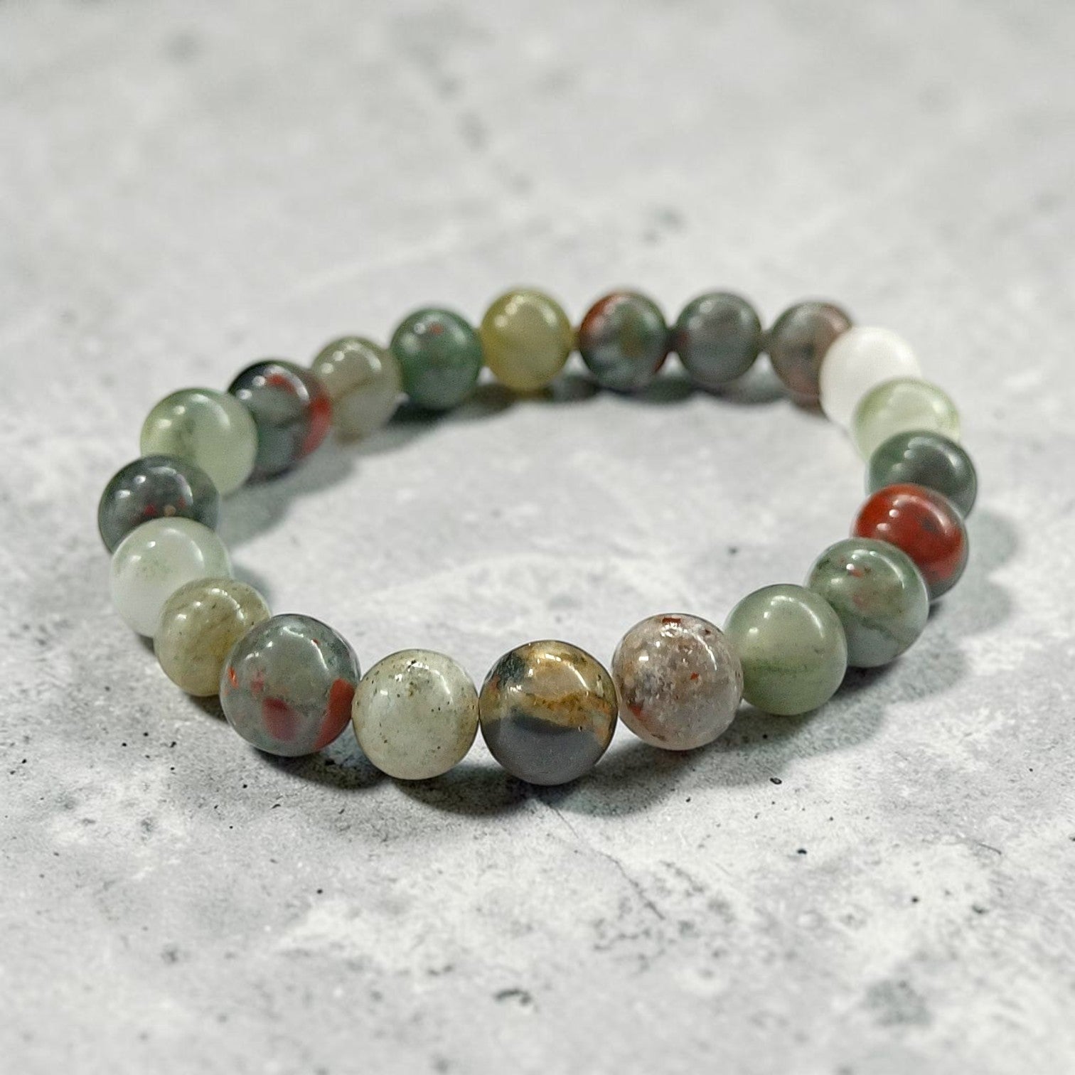 JewelOn 8mm Bloodstone crystal bracelet with red and green marbled beads, unisex design for grounding and courage.