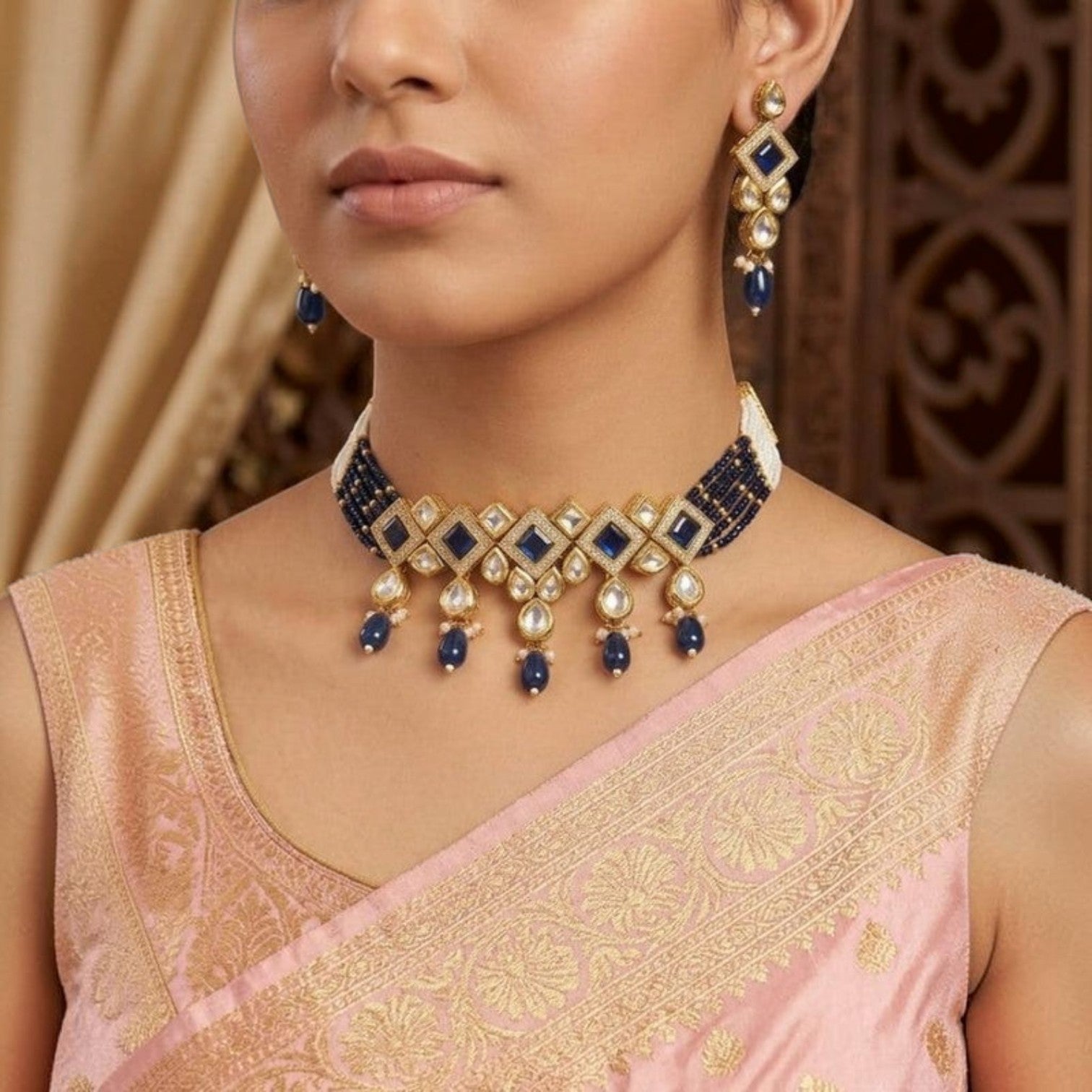 JewelOn blue kundan choker necklace set with matching earrings, featuring gold-tone accents and intricate blue beadwork.