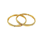 JewelOn gold plated bangles set with intricate detailing and a central ruby accent.
