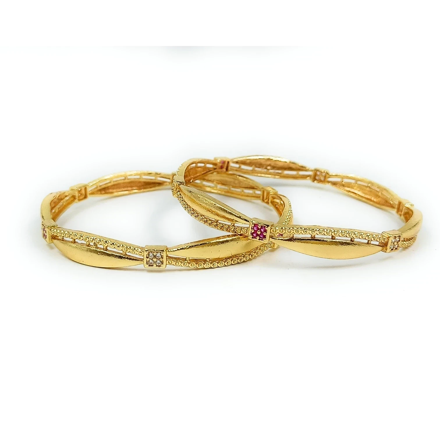 JewelOn gold plated bangles set with intricate detailing and small red and clear stones.