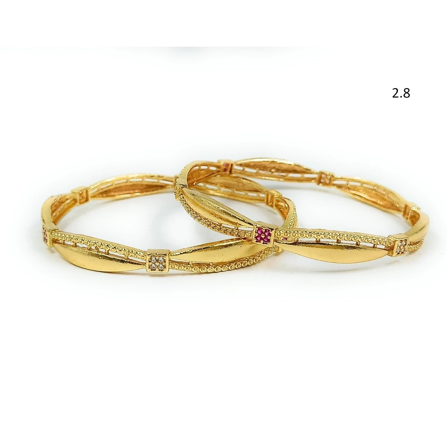JewelOn gold plated bangles set with intricate detailing and small ruby and diamond accents.