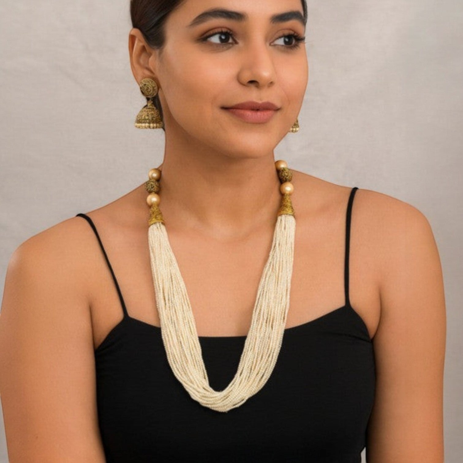 JewelOn layered pearl necklace and jhumka earrings set with gold-toned accents. Delicate white pearls form multiple strands.