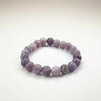 JewelOn Lepidolite 8mm crystal bracelet with smooth, lilac and lavender beads on an elastic band.