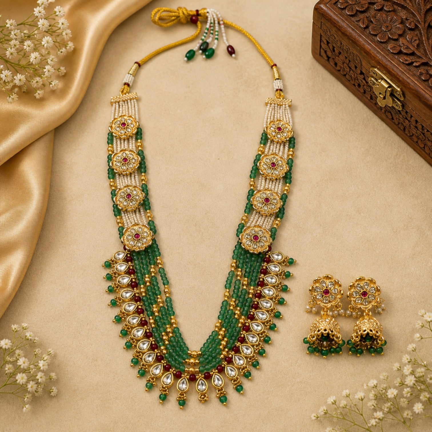 JewelOn Haritima mint green Monzonite Kundan pearl long necklace set with matching earrings. Intricate gold-tone floral motifs with red stones and pearls.