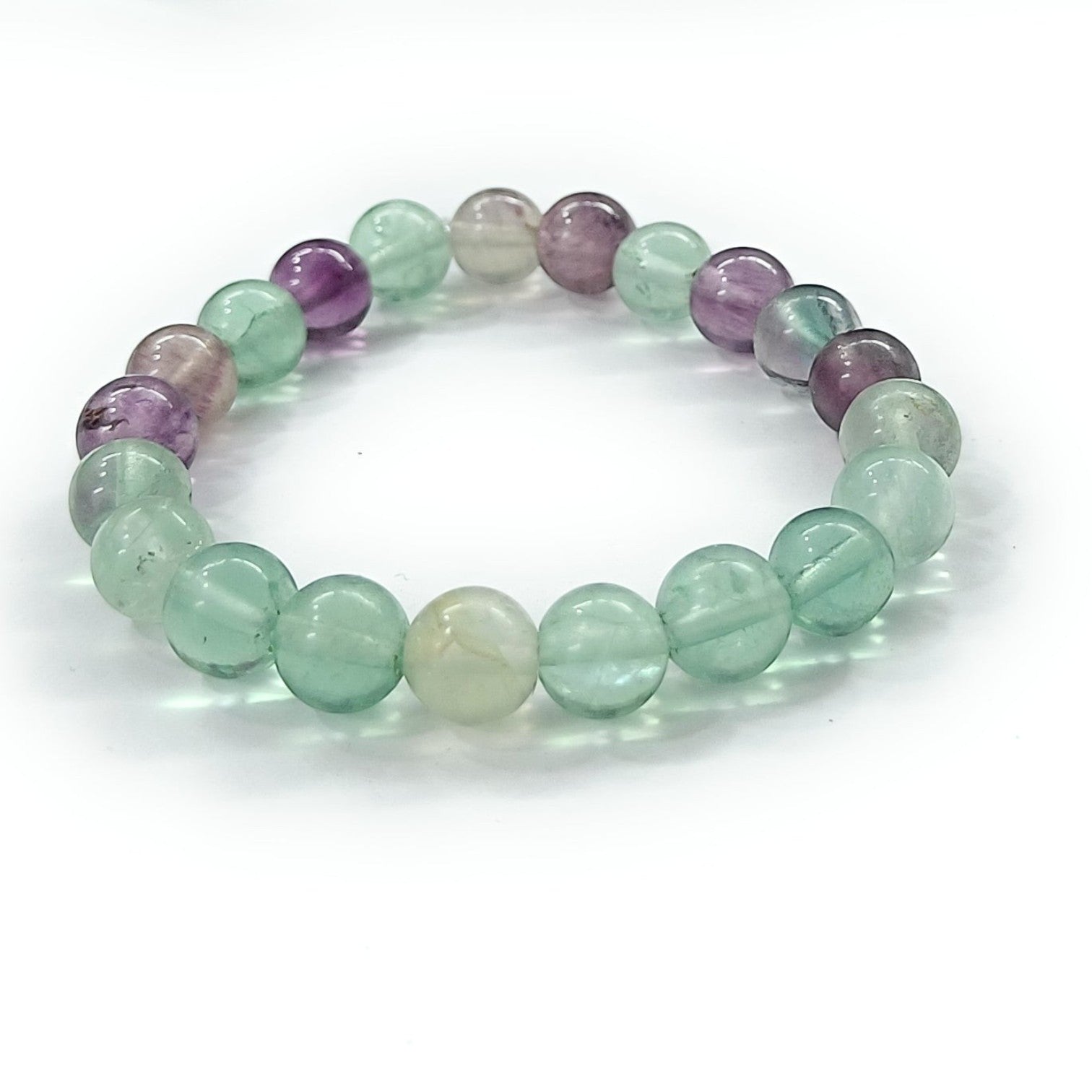 JewelOn bracelet with 8mm multi fluorite beads in shades of purple, green, and clear. Elastic cord.