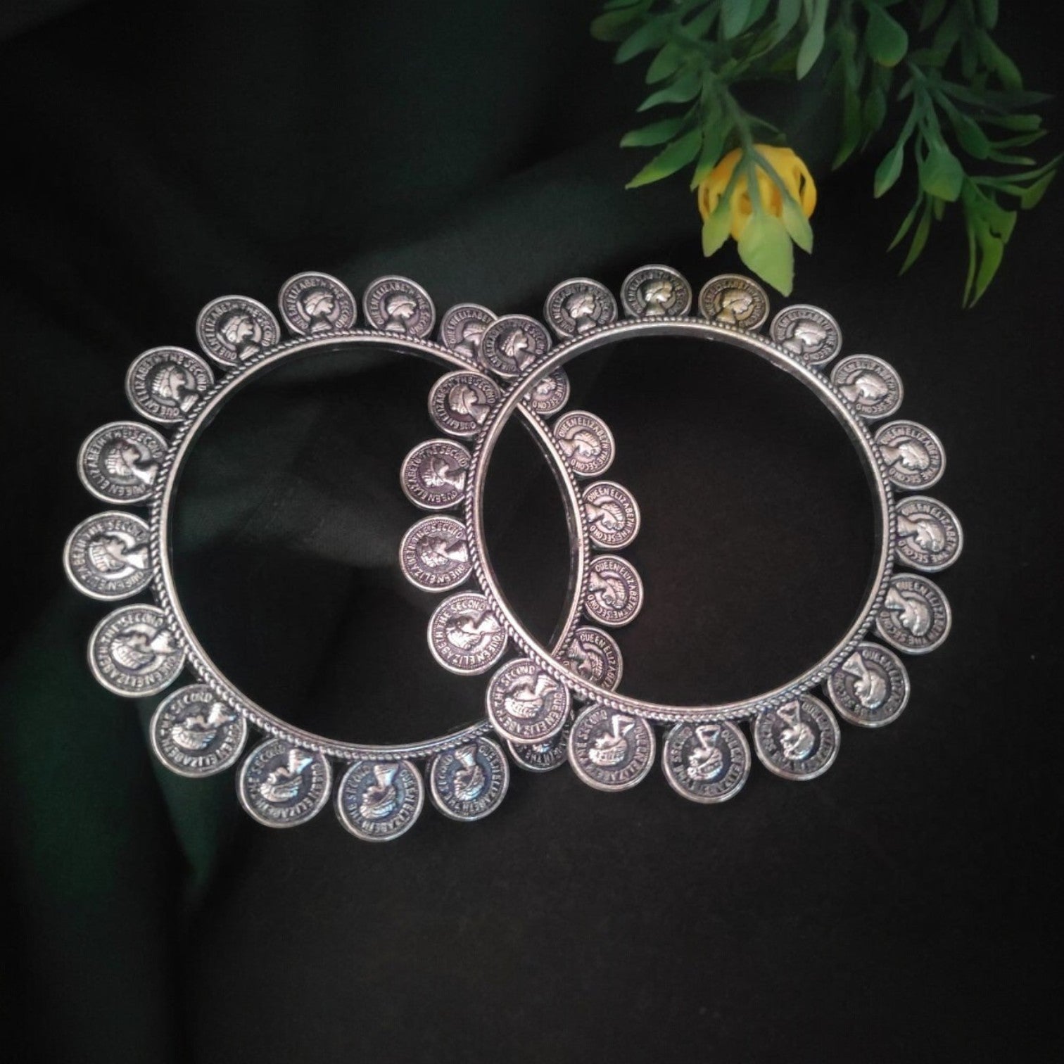 JewelOn Divine Blend Stylish Oxidised Bangles 2.6, featuring a circular design with embossed Queen Elizabeth II profiles and bird motifs.