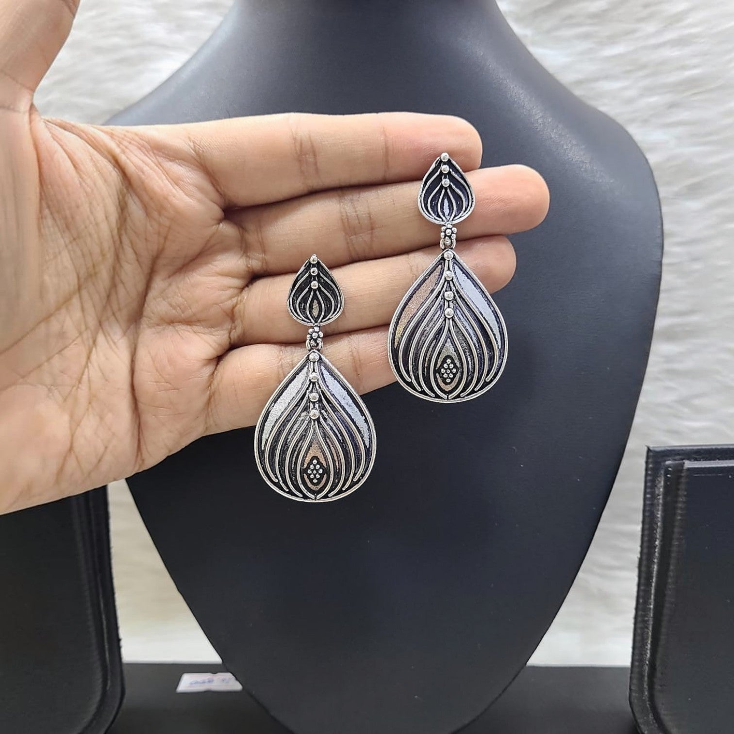 JewelOn Classy German Silver Oxidised Drop Earrings with intricate leaf design and small beaded accents.