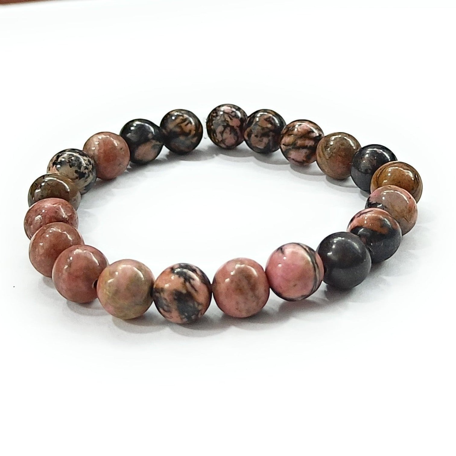 JewelOn 8mm genuine Rhodonite crystal beads bracelet with rose-pink hues and black inclusions, strung on elastic cord.