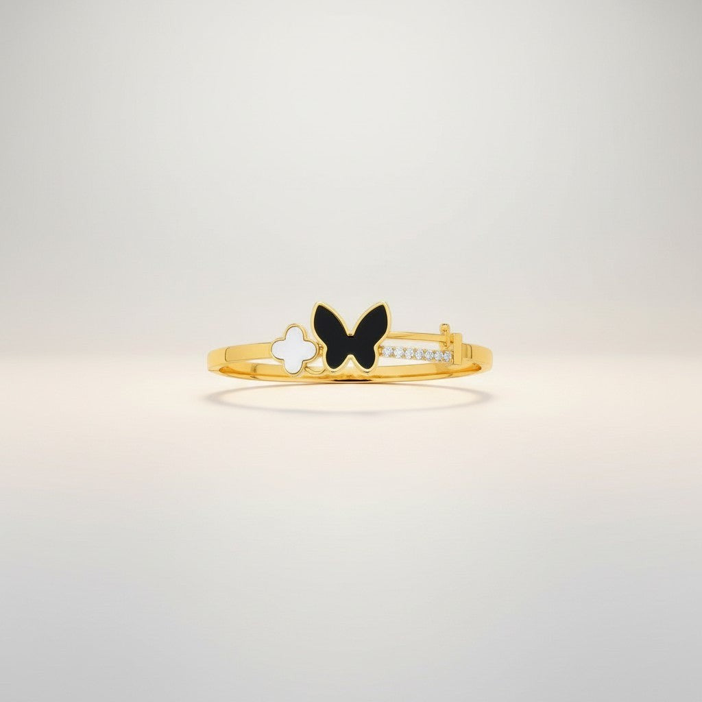 JewelOnHere gold-tone stainless steel cuff bracelet with black enamel butterfly, white clover charm, and cubic zirconia accents.