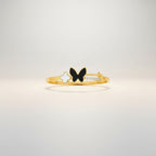 JewelOnHere gold-tone stainless steel cuff bracelet with black enamel butterfly, white clover charm, and cubic zirconia accents.