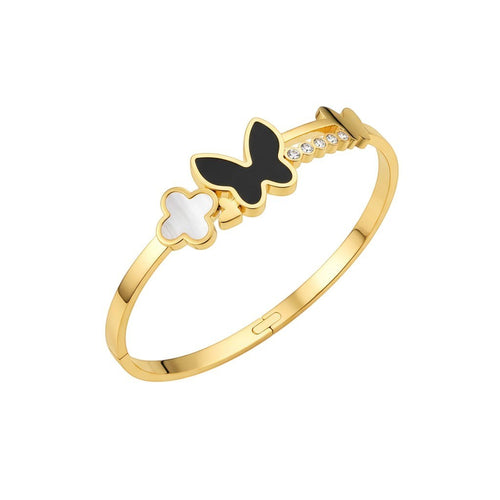 JewelOnHere gold-tone stainless steel cuff bracelet with black enamel butterfly, white clover charm, and cubic zirconia.
