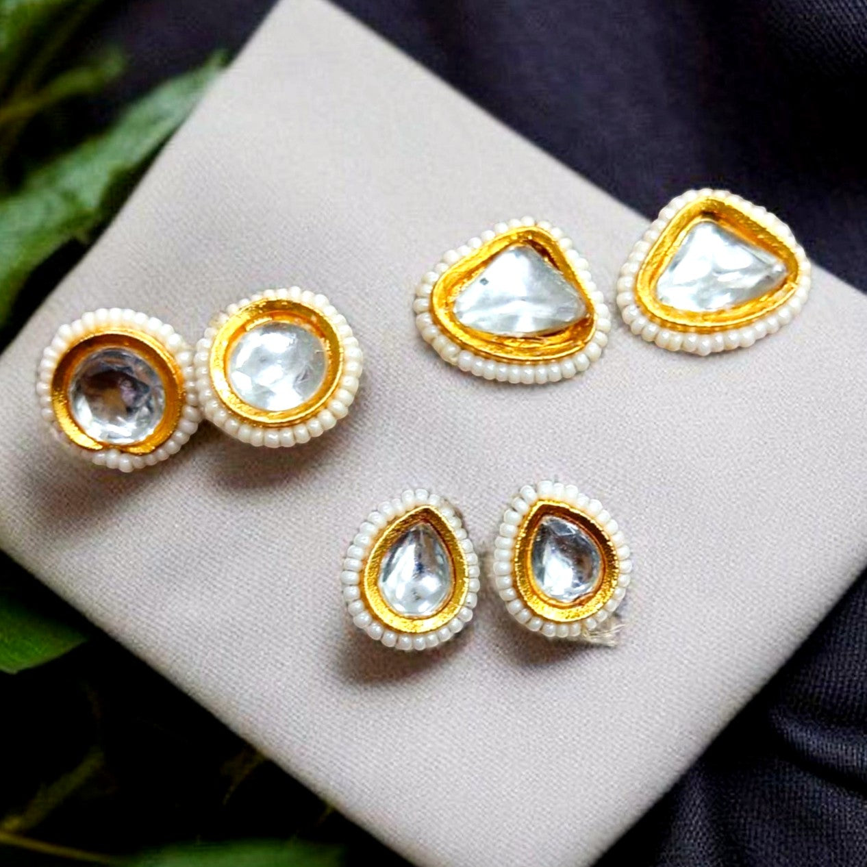 JewelOnHere Kundan stud earrings combo for women, featuring clear stones in gold-tone settings with white bead accents.