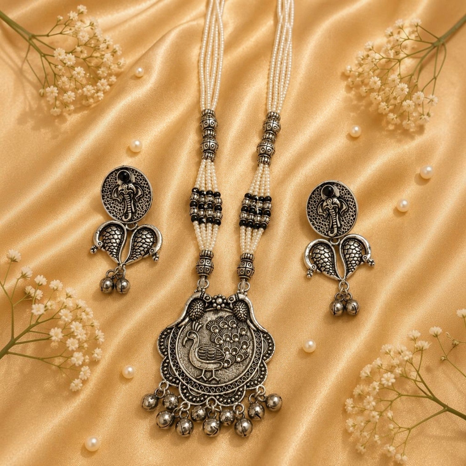 JewelOnHere oxidized German silver necklace and earrings set with pearl beads and peacock pendant.